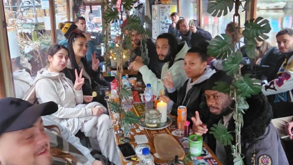 Group of people sitting at a festive table with drinks and snacks.